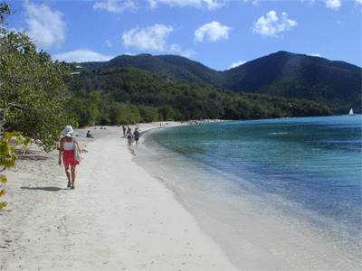 Susie walking down beach at Francis Bay